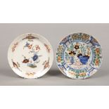 Two 18th century Continental polychrome delft plates. Each painted with flowers, largest 22.25cm