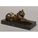 An Art Deco style bronze sculpture after Michel DeCoux. Formed as a recumbent wild cat on a slate