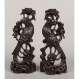 A pair of Chinese hardwood carvings each formed as a stylized phoenix, 31.5cm.Condition report