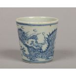 An antique Chinese blue and white beaker of tapering form. Painted in underglaze blue with a