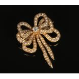 A 15 carat gold diamond and seed pearl brooch formed as a triple bow. 8.64 grams, 38mm.Condition