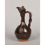 A 19th century Turkish Canakkale pottery ewer. Decorated in a brown glaze and with sprigged