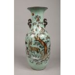 A 19th century Chinese celadon floor vase of baluster form and having flat stylized dragon