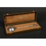 A boxed French silver soup ladle by Christofle. With engraved cipher to the terminal, Minerva