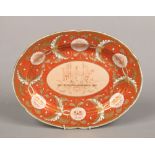 A Herculaneum lobed serving platter. Ground in burnt orange and with a wide border of gilt