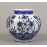 A Turkish Iznik style lobed vase. Painted with stylized flowers in blue glazes, 14cm.Condition