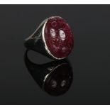 An 18 carat white gold ring set with a large antique carved tourmaline scarab beetle. 14.69 grams,