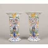 A pair of 19th century Dutch Delft polychrome vases of flattened hexagonal form. Each moulded with