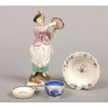 An early 19th century Staffordshire pearlware figure of a girl playing a tambourine, a saltglaze