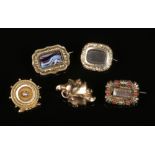 Three Georgian pinchbeck mourning brooches and two other yellow metal brooches, one set with a