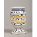 An early 19th century Continental polychrome delft drug jar or albarelli. Painted blue and yellow