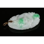 A Chinese white jade pendant with spinach green suffusion and 14 carat gold clasp. Finely carved