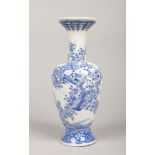 A Japanese Meiji period blue and white baluster vase. Painted in underglaze blue with a bird perched