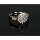 A 9 carat gold diamond cluster ring. Size L.