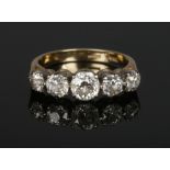 An 18 carat gold five stone diamond ring. Set with five graduated Old European cut diamonds.