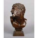 A 19th century patinated bronze bust of oversize proportions. Modelled in the Greek style as a man