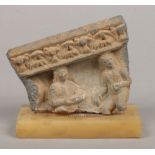 A small Ghandara stone fragment incorporating figures and raised on an associated onyx plinth, 11.