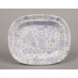 A Twigg Newhill pottery blue and white meatplate. Decorated with flower sprigs over a cell ground.