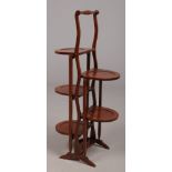 An Edwardian inlaid mahogany double sided four tier folding cake stand, 89cm.Condition report