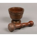 A 19th century Continental turned fruitwood mortar and pestle, 12.5cm diameter.Condition report