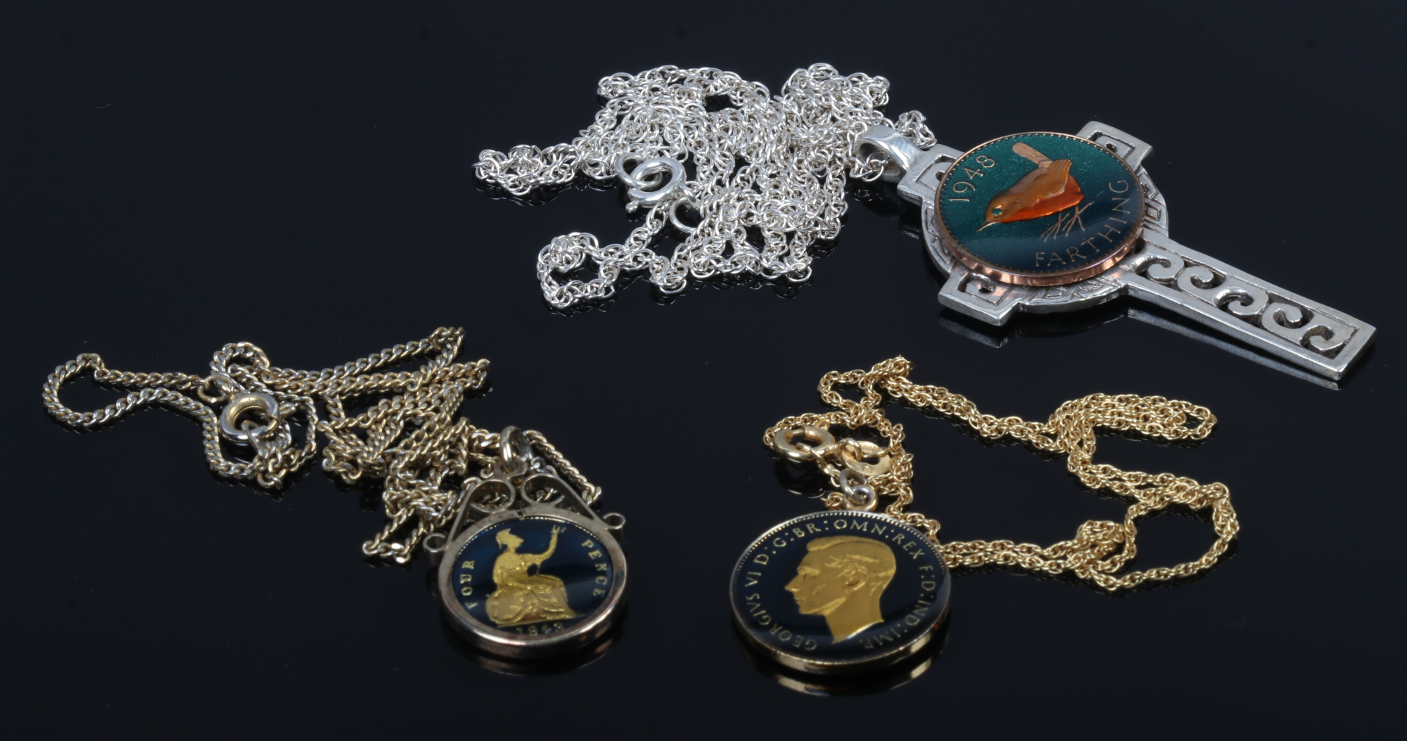 Three gilded and enamelled pre-decimal coins on chains to include 9ct gold chain and silver Celtic