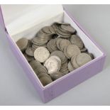 A box containing over 150 British pre-decimal six pences.