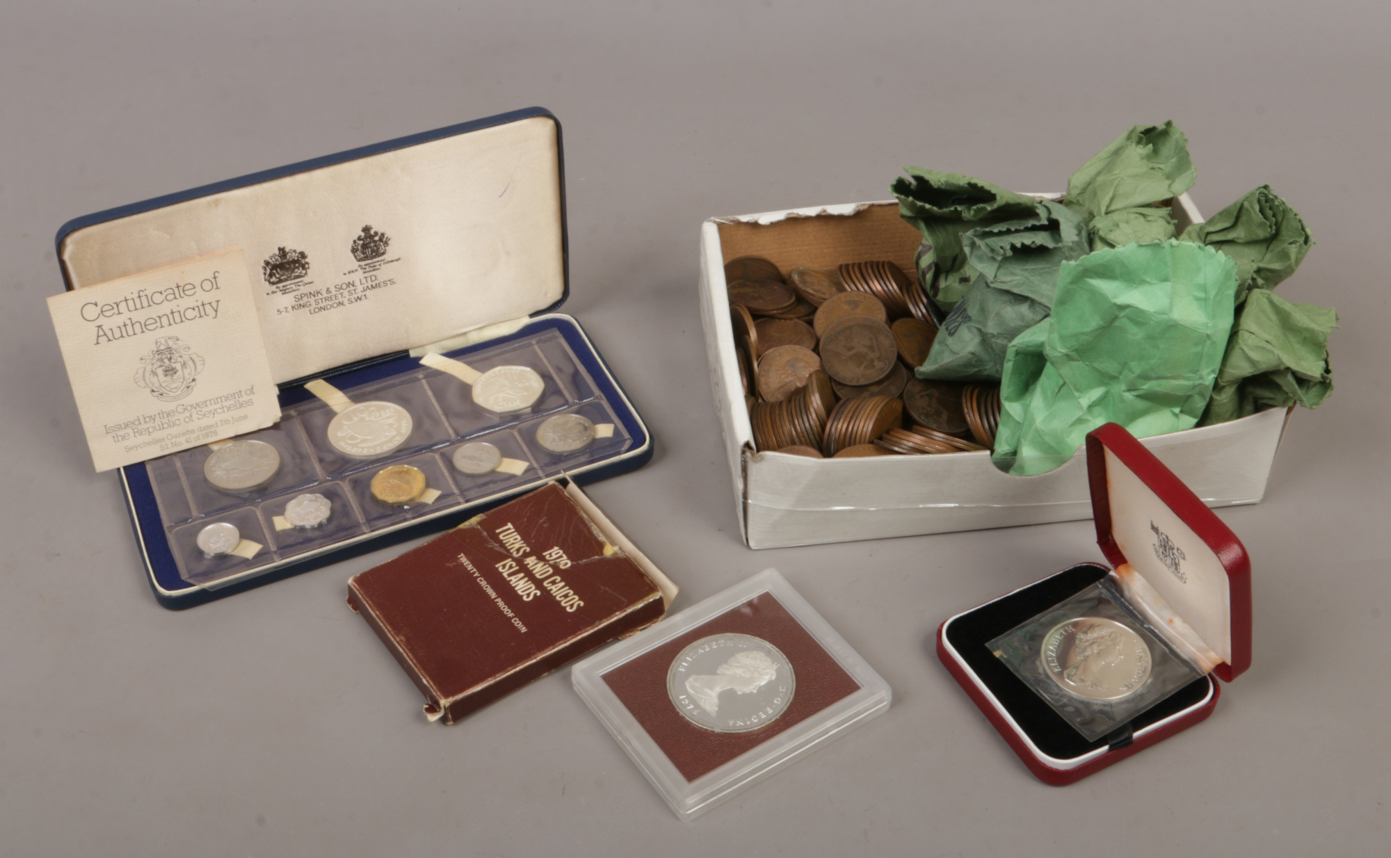 A box of vintage coins to include penny and three penny pieces, along with a cased republic of