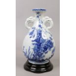 A Japanese blue and white bottle vase. With twin mask handles and painted in underglaze blue with