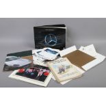 A collection of motoring ephemera to include Shell-Mex and BP 1956 caricature book, Porsche car