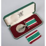 A cased women's voluntary service medal with an extra ribbon.