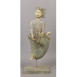 A decorative painted and giltwood statue, formed as a musician playing a stringed instrument. Made