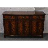 A rackstraw flame mahogany bow front sideboard raised on bracket feet.