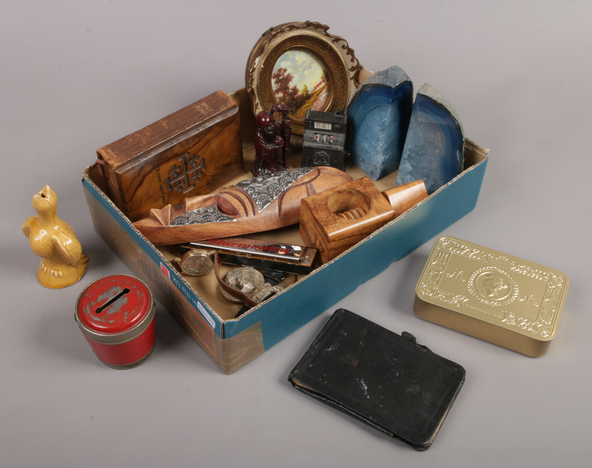 A box of collectables including mineral geode bookends, novelty nut cracker, vintage tin plate