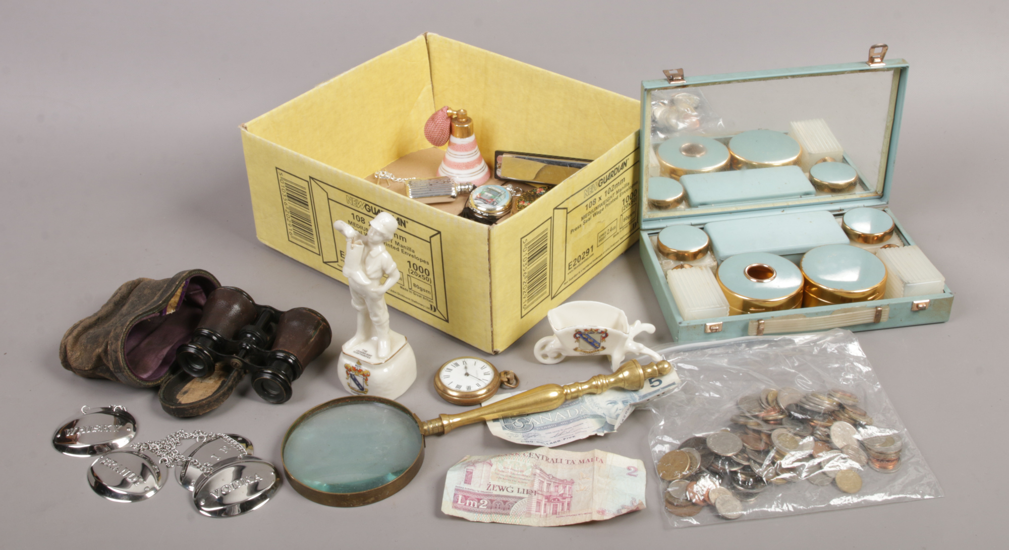 A box of collectables including crested wares, British pre-decimal and foreign coins, brass