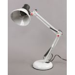 A white anglepoise table lamp.