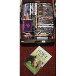 A box of DVDs and C.Ds including action and comedy movies, rock and pop music etc.