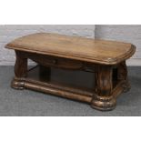 A carved oak two tier coffee table.