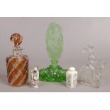 An Art Deco green glass scent bottle with oversized stopper decorated with a semi clad maiden, a