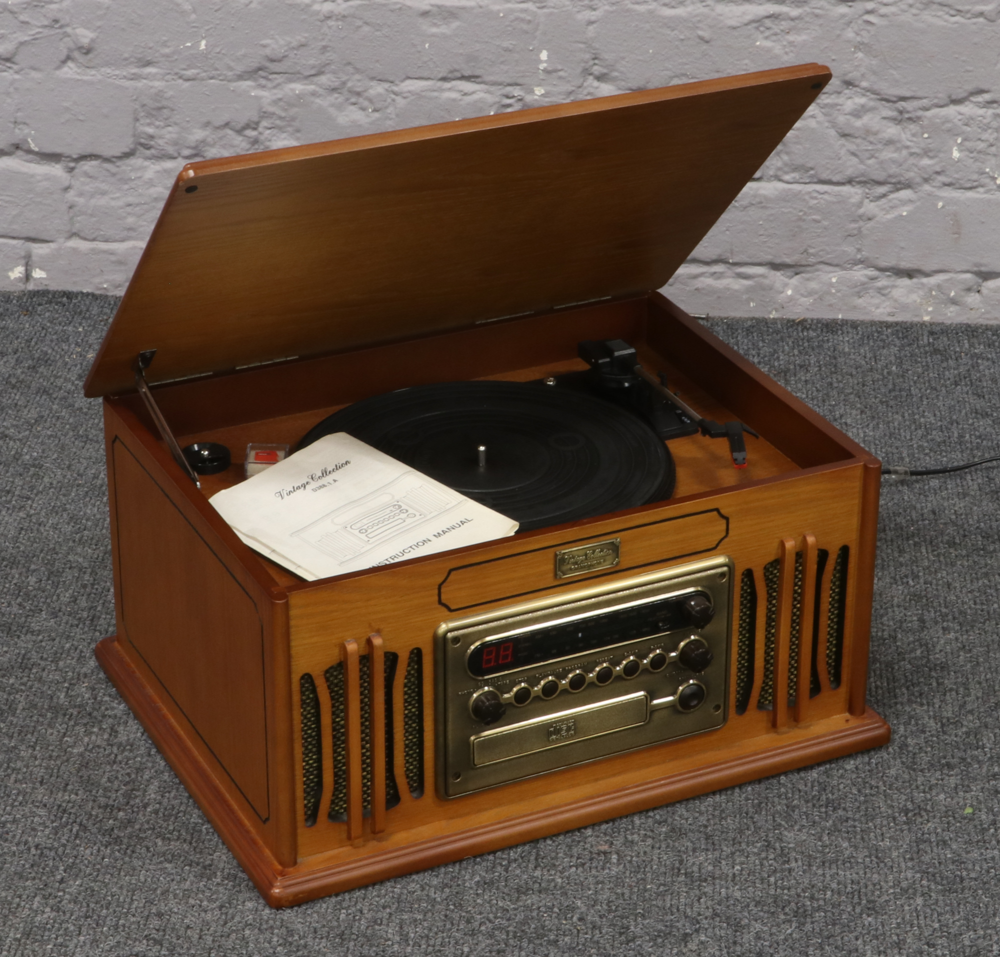 A vintage gramophone with built in turntable, tuner and CD player complete with instruction