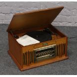 A vintage gramophone with built in turntable, tuner and CD player complete with instruction