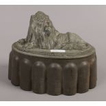 A Victorian jelly mould decorated with a recumbent lion stamped F56.