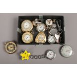 A box of assorted pendant and ring watches.