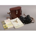 A cased pair of Carl Zeiss 10 x 50 field binoculars, along with two McHardy's fishing tackle