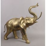 A large ornamental brass model of an African elephant, 71cm at tallest point, 79cm in length.