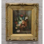 J. Hamilton gilt framed oil on board Dutch style floral still life, signed.