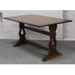 A carved oak refectory table, along with four matching dining chairs with floral upholstered seat