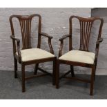 A pair of Hepplewhite style carver armchairs with upholstered seats.