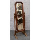 A mahogany bevel edge glass cheval dressing mirror with turned supports.