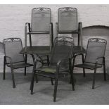 A metal garden table along with six matching garden chairs.