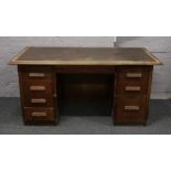 A 1930s office desk with inlaid leather top.